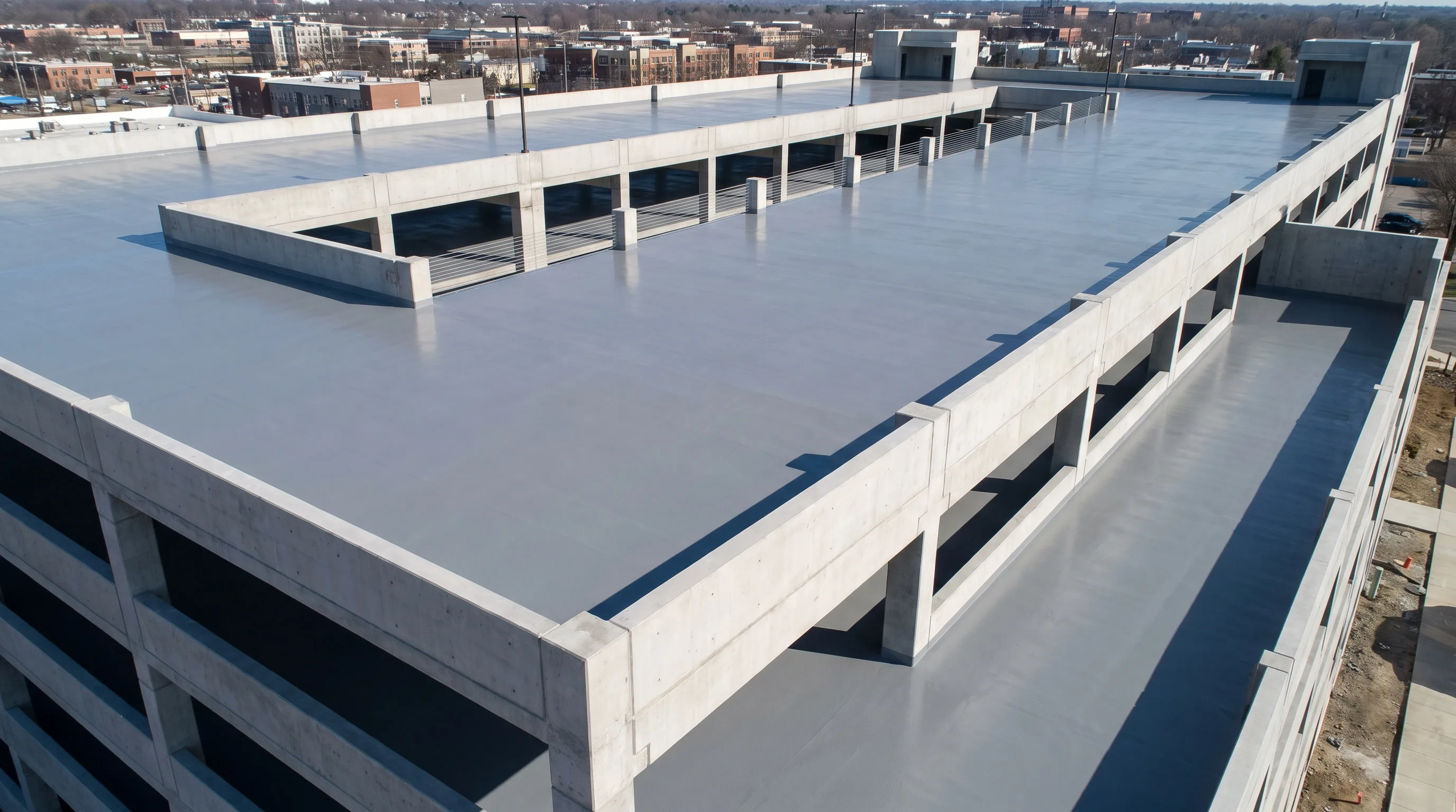 Aerial view of a multi-level concrete parking deck coated with a polyurea waterproofing membrane